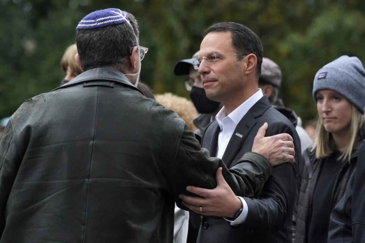 FILE - Pennsylvania Attorney General Josh Shapiro, center, attends a Commemoration Ceremony in Schenley Park, in Pittsburgh's Squirrel Hill neighborhood, on Wednesday, Oct. 27, 2021, three years after a gunman killed 11 worshippers at the Tree of Life Synagogue. Shapiro will be taking office as Pennsylvania's next governor in January 2023 after running a campaign in which he spoke early and often about his Jewish religious heritage. (AP Photo/Gene J.