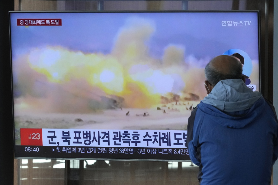 FILE - A TV screen shows a file image of North Korea's military exercise during a news program at the Seoul Railway Station in Seoul, South Korea, Wednesday, Oct. 19, 2022. South Korea's military says North Korea has fired around 130 suspected artillery rounds Monday, Dec. 5, 2022, in waters near the rivals' western and eastern sea borders in another display of belligerence.