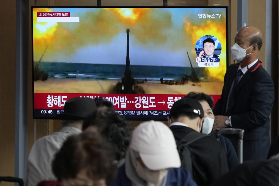 A TV screen shows a file image of North Korea's military exercise during a news program at the Seoul Railway Station in Seoul, South Korea, Friday, Oct. 14, 2022. North Korea's military Tuesday, Dec. 6, 2022, says it has ordered frontline units to conduct artillery firings into the sea for the second consecutive day in a tit-for-tat response to South Korean live-fire drills in an inland border region.
