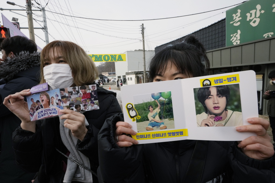 Fans wait for K-pop band BTS's member Jin to arrive before he enters the army to serve near an army training center in Yeoncheon, South Korea, Tuesday, Dec. 13, 2022. Jin, the oldest member of K-pop supergroup BTS, was set to enter a frontline South Korean boot camp Tuesday to start his 18 months of mandatory military service, as fans gathered near the base to say goodbye to their star.