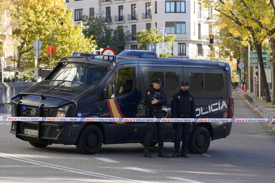 Police officers stand guard as they cordon off the area next to the U.S. embassy in Madrid, Spain, Thursday, Dec. 1, 2022. Spanish officials say a suspicious envelope has been discovered at the U.S. Embassy in Madrid and placed under police control. The finding on Thursday came as police reported a wave of explosive packages being sent in Spain's capital, including one that ignited at the Ukrainian Embassy.