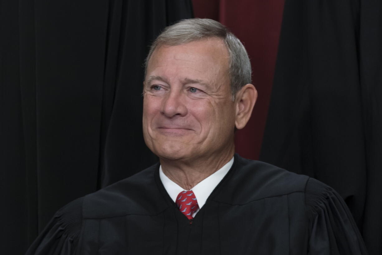 FILE - Chief Justice of the United States John Roberts joins other members of the Supreme Court as they pose for a new group portrait, at the Supreme Court building in Washington, Oct. 7, 2022. (AP Photo/J.