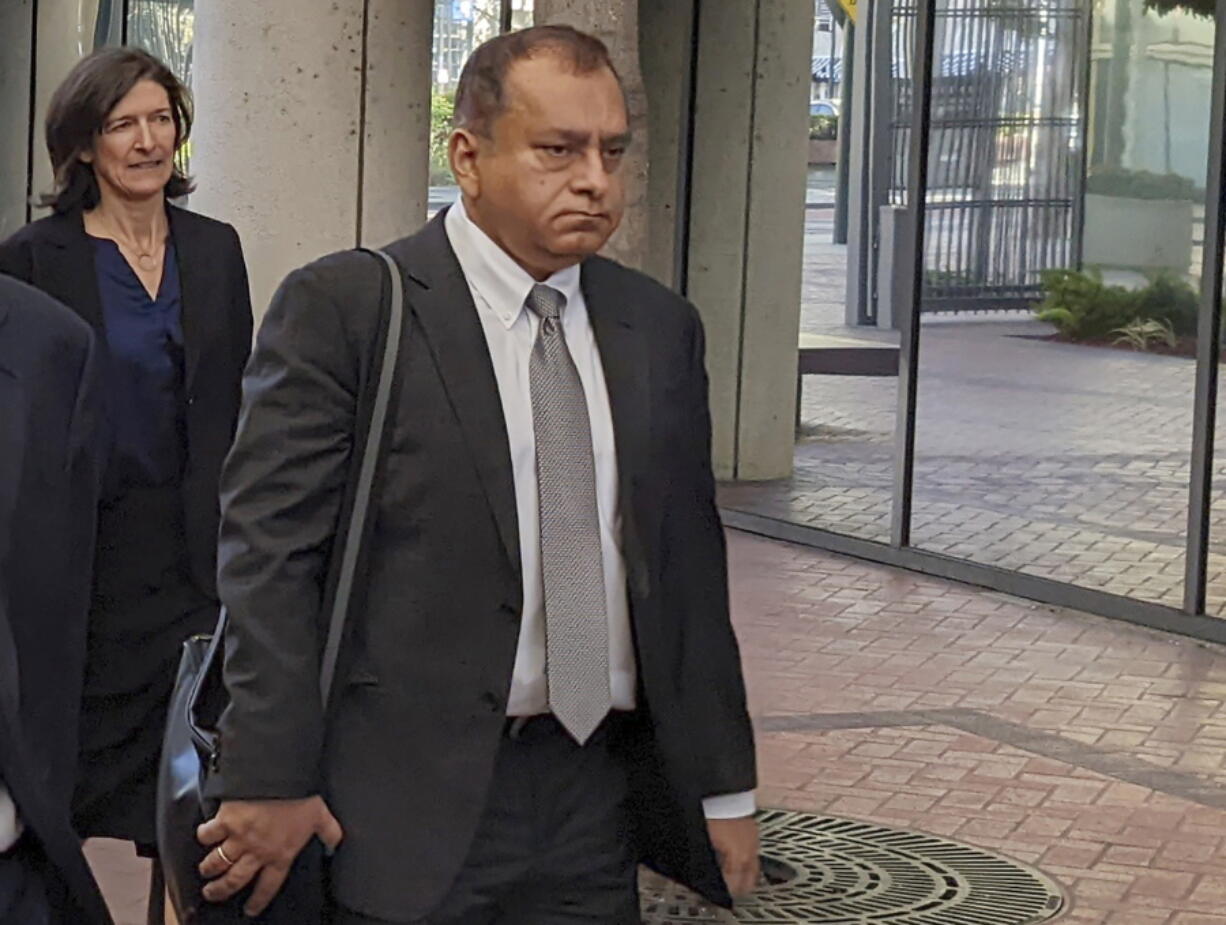 FILE - Ramesh "Sunny" Balwani, right, the former lover and business partner of Theranos CEO Elizabeth Holmes, walks into federal court in San Jose, Calif., on June 24, 2022. Balwani learns Wednesday, Dec. 7, 2022, whether he will be punished as severely as Holmes for peddling the company's bogus blood-testing technology that duped investors and endangered patients.