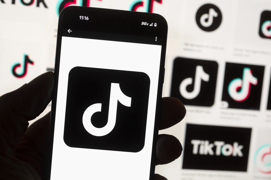 FILE - The TikTok logo is seen on a cell phone on Oct. 14, 2022, in Boston. TikTok would be banned from most U.S. government devices under a government spending bill Congress unveiled early Tuesday, the latest push by American lawmakers against the Chinese-owned social media app.