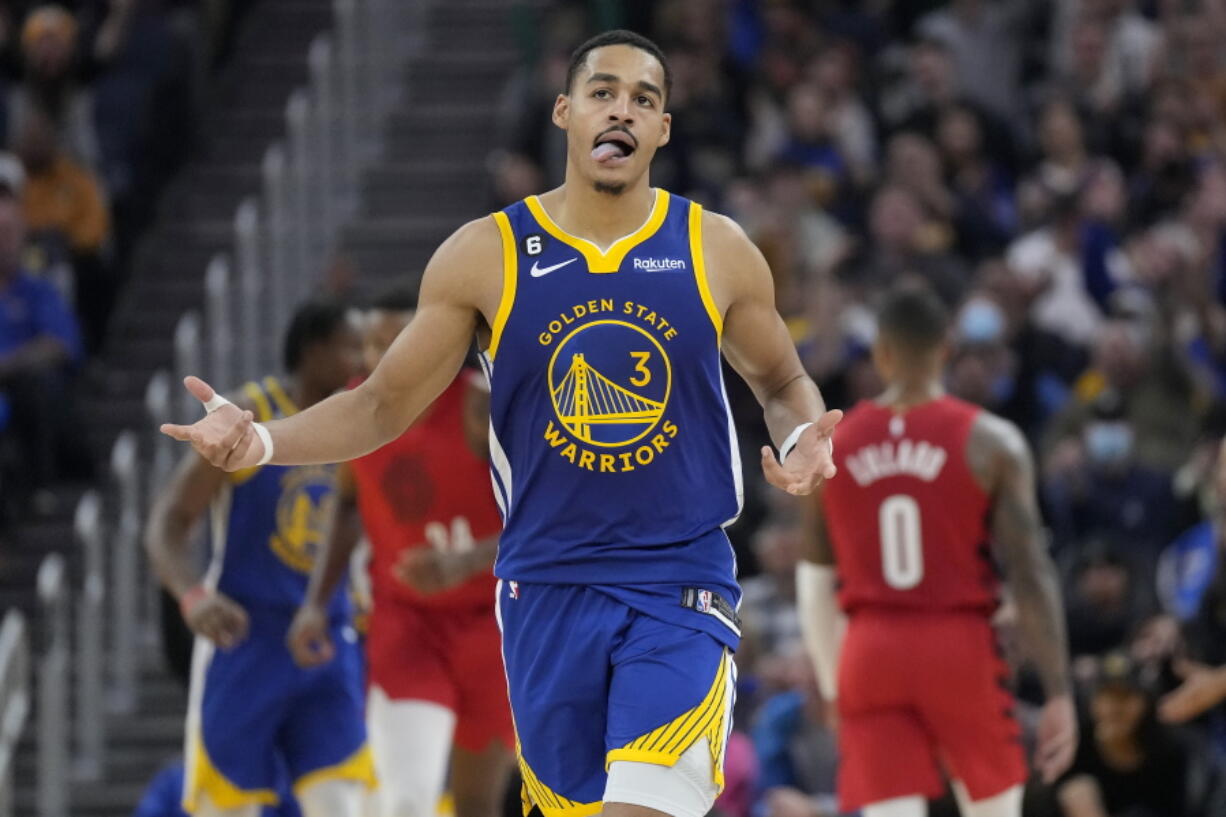 Golden State Warriors guard Jordan Poole (3) gestures after 3-point basket during the first half of the team's NBA basketball game against the Portland Trail Blazers in San Francisco, Friday, Dec. 30, 2022.