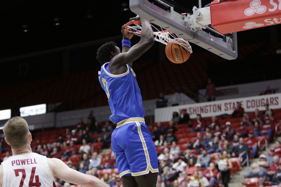 UCLA forward Adem Bona dunks during the first half of the team's NCAA college basketball game against Washington State, Friday, Dec. 30, 2022, in Pullman, Wash.