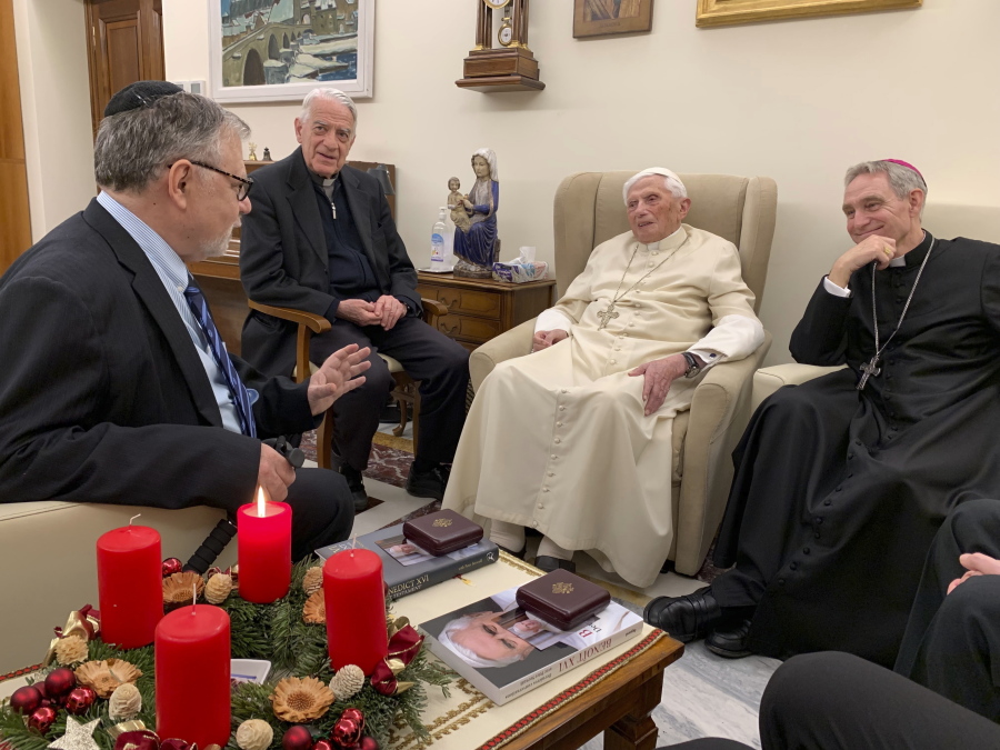 Pope Emeritus Benedict XVI, third from left, meets with the winners of the 2022 Ratzinger Prize, Joseph Halevi Horowitz Weiler, left, and father Michel Fedou, partially hidden at right, at the Mater Ecclesiae monastery inside the Vatican where Benedict XVI lives, in this photo taken Thursday, Dec. 1, 2022. Second from left, is the foundation's president Father Federico Lombardi, and fourth from left is Benedict XVI's long-time personal secretary Bishop Georg G?nswein.