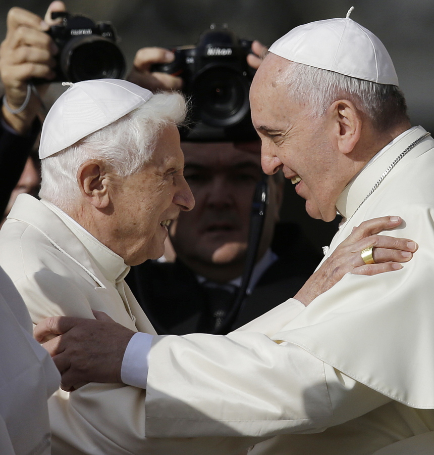 FILE - Pope Francis, right, hugs Pope Emeritus Benedict XVI prior to the start of a meeting with elderly faithful in St. Peter's Square at the Vatican, Sunday, Sept. 28, 2014. Pope Francis on Wednesday, Dec.