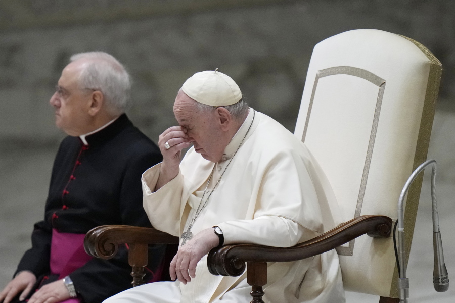 Pope Francis, right, sits next to Monsignor Leonardo Sapienza, left, as they attend the weekly general audience in the Paul VI Hall at the Vatican, Wednesday, Dec. 28, 2022.
