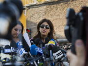 FILE  - Italian communications expert Francesca Chaouqui talks to journalists July 7, 2016, after a Vatican court convicted her and a Vatican monsignor for having conspired to pass documents to two Italian journalist.  A Vatican trial into a money-losing investment has been jolted by revelations that a key prosecution witness was apparently manipulated into changing his story and cooperating with prosecutors.