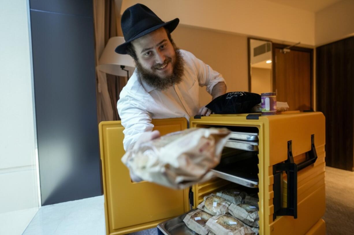 Eli Chitrik from Turkey shows bagel sandwiches in his hotel room in Doha, Qatar, on Monday.