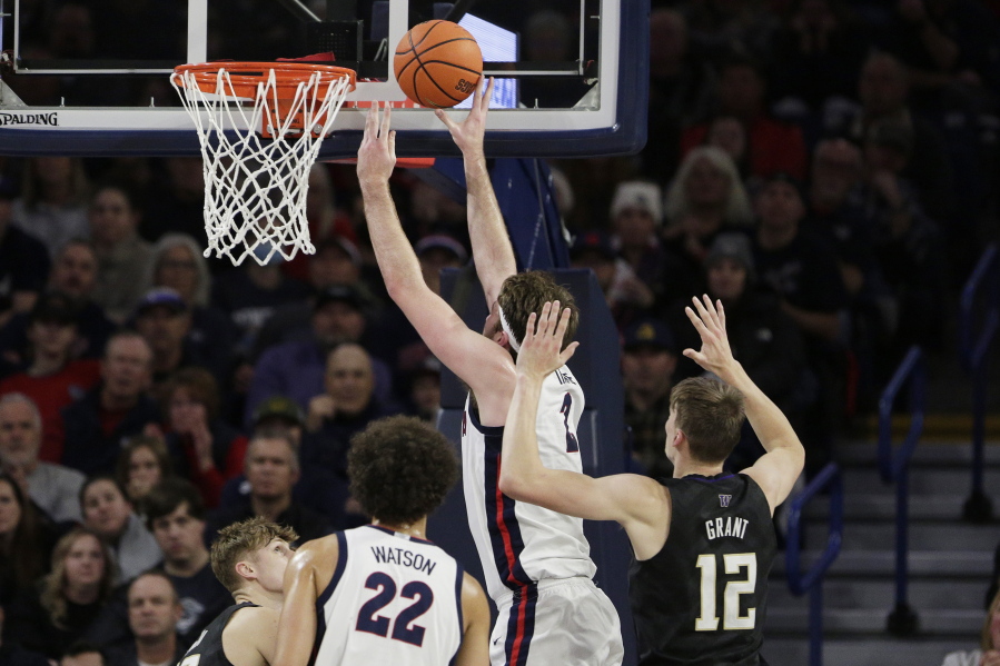 Gonzaga forward Drew Timme (2), second from right, shoots in front of Washington forward Jackson Grant (12) during the first half of an NCAA college basketball game, Friday, Dec. 9, 2022, in Spokane, Wash.