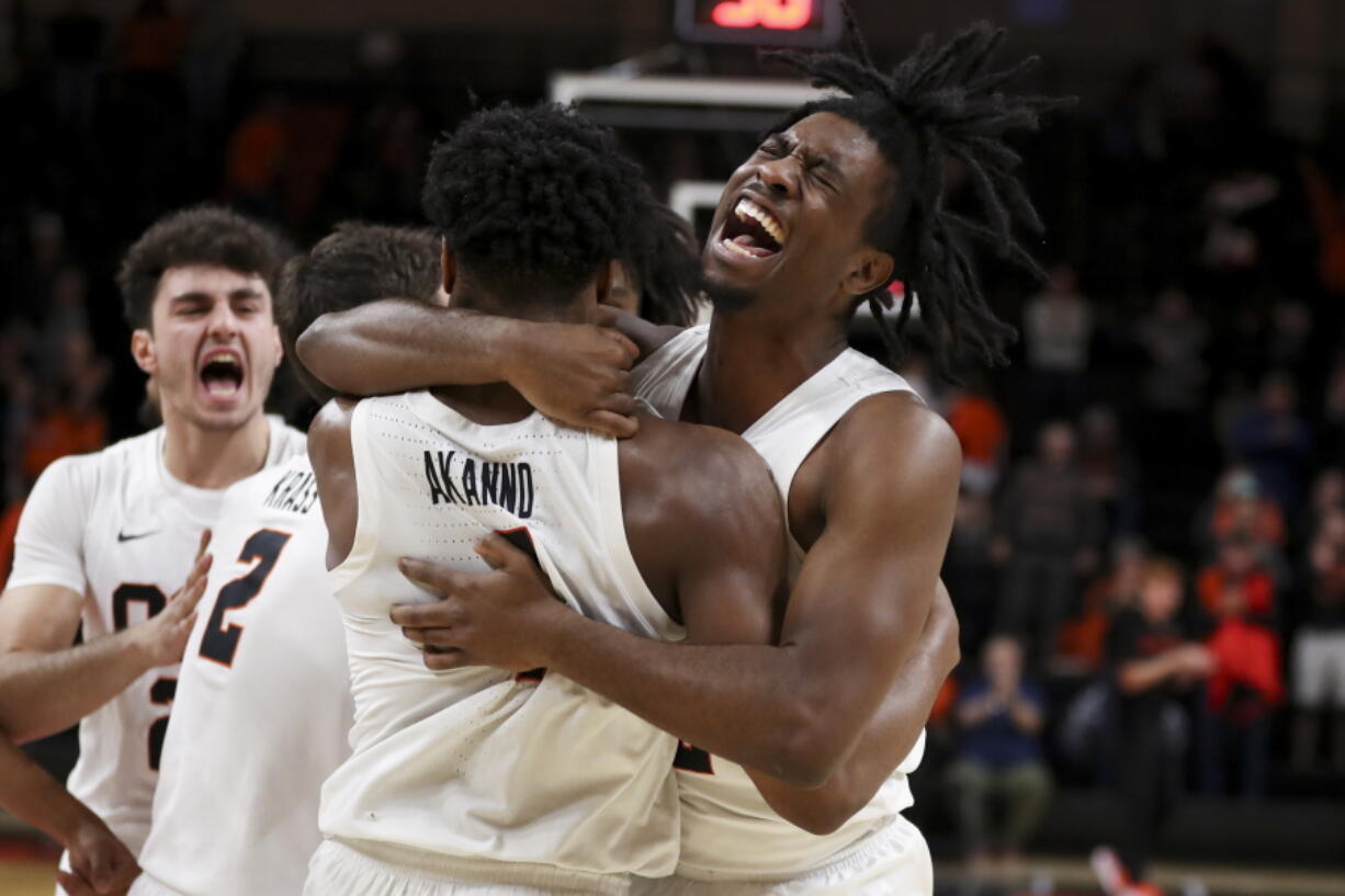 Oregon State guard Donovan Grant, right, hugs Dexter Akanno while celebrating the team's 66-65 win over Washington in an NCAA college basketball game Thursday, Dec. 1, 2022, in Corvallis, Ore.