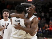 Oregon State guard Donovan Grant, right, hugs Dexter Akanno while celebrating the team's 66-65 win over Washington in an NCAA college basketball game Thursday, Dec. 1, 2022, in Corvallis, Ore.