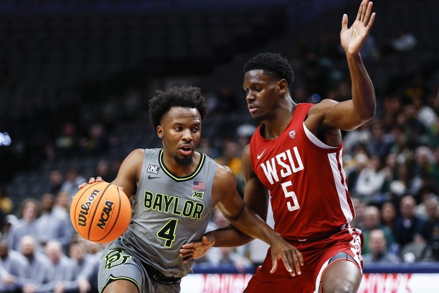 Baylor guard LJ Cryer (4) battles Washington State guard TJ Bamba (5) for space during the first half of an NCAA college basketball game on Sunday, Dec. 18, 2022, in Dallas.
