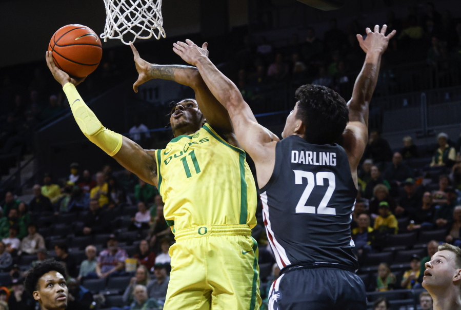 Oregon guard Rivaldo Soares (11) shoots against Washington State guard Dylan Darling (22) during the first half of an NCAA college basketball game in Eugene, Ore., Thursday, Dec. 1, 2022.