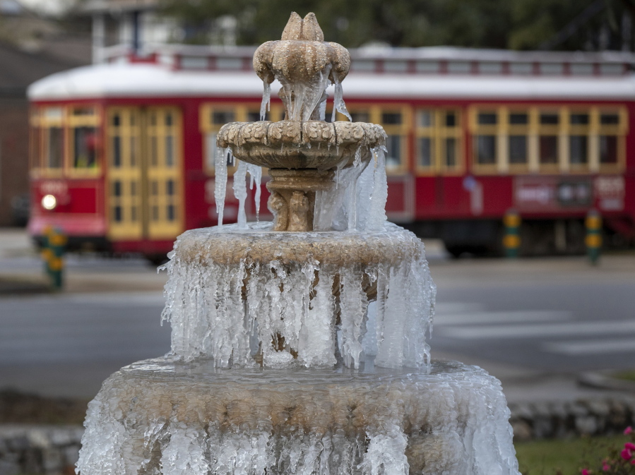 The fountain is frozen as temperatures hovered in the mid 20's at Jacob Schoen & Son Funeral Home in New Orleans, Saturday, Dec. 24, 2022.
