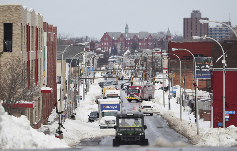 Vehicles drive down Jefferson Avenue in Buffalo. N.Y., on Wednesday, Dec. 28, 2022. Clean-up efforts remain underway after a blizzard hit four Western New York counties.