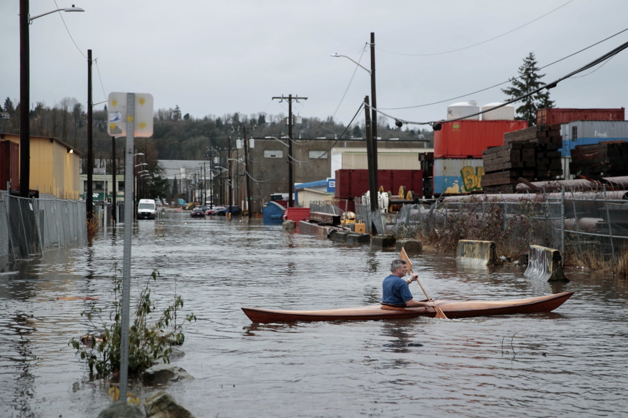 A person kayaks on South Portland Street in Seattle's South Park neighborhood Tuesday morning, Dec. 27, 2022.