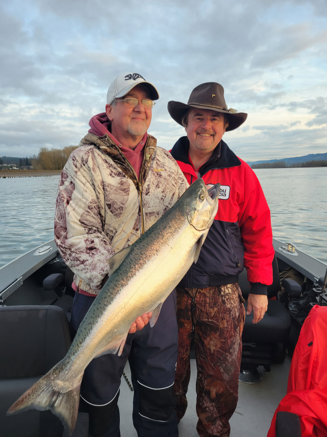 Outdoor writer Bill Herzog (left) and Buzz Ramsey pose with a 2022 Columbia River spring Chinook. The states have released projections for the 2023 return of Spring Chinook, and they offer anglers optimism for the coming year.
