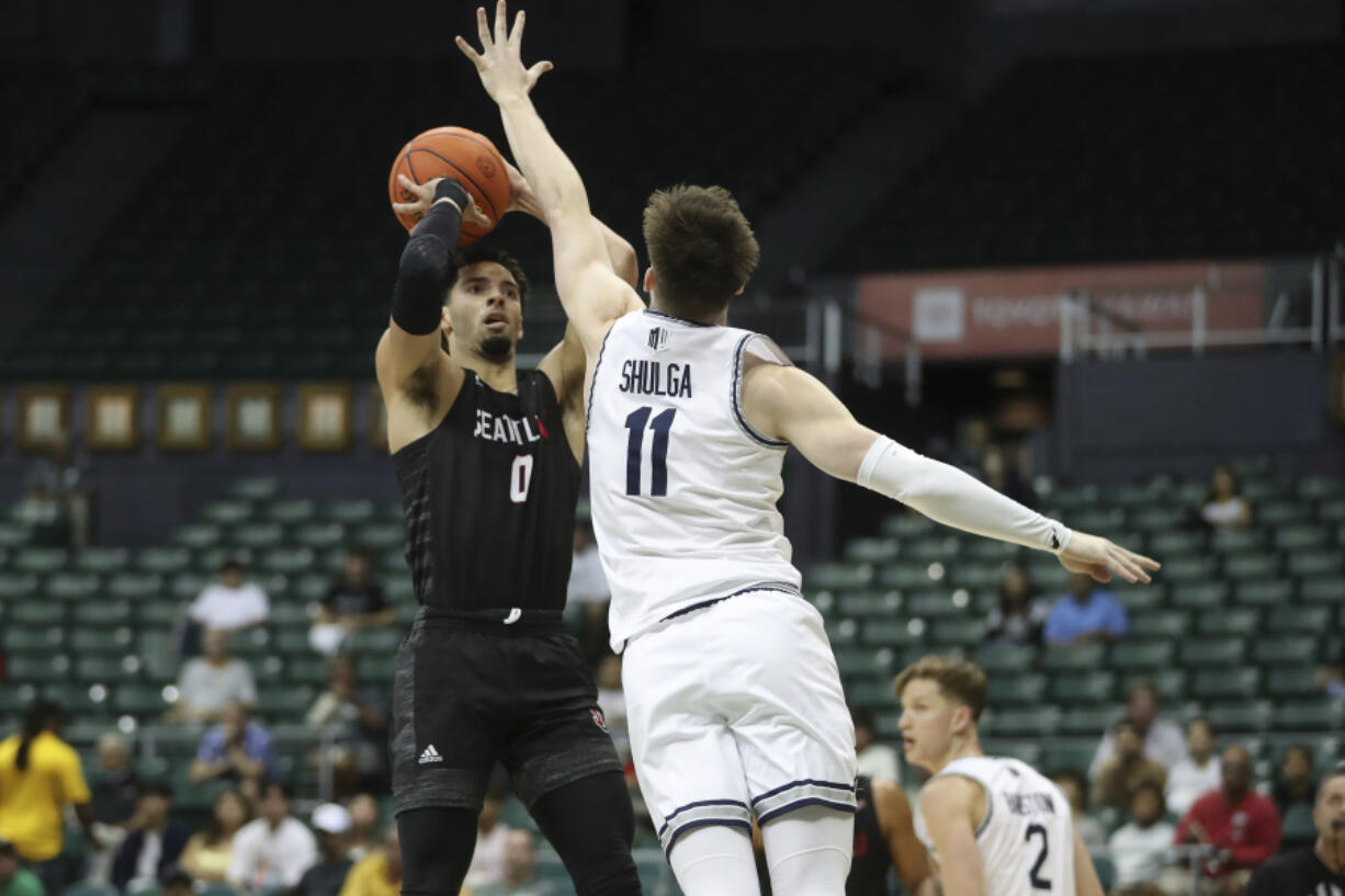 Seattle U. guard Alex Schumacher (0) shoots over Utah State's Max Shulga (11) during a game in the Diamond Head Classic in December at Honolulu.