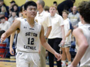 Seton Catholic’s Lance Lee, left, high fives teammate Brady Angelo, right, at halftime of a Trico League boys basketball game  against King’s Way Christian on Thursday, Jan. 12, 2023, in Vancouver.