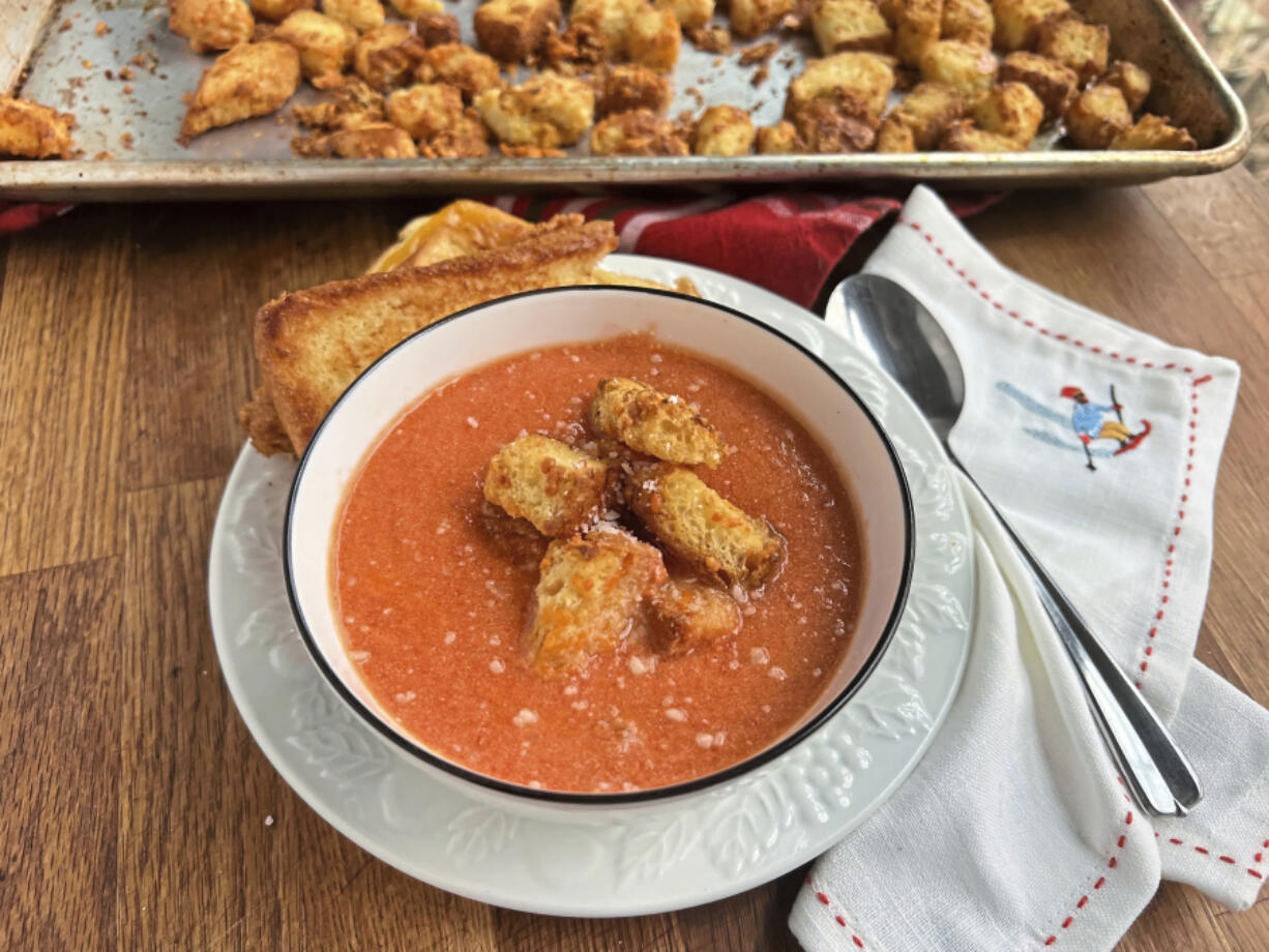 Homemade tomato soup topped with crunchy, cheesy croutons is an easy midweek meal.