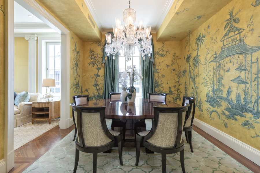 Hand-painted original art creates a traditional and formal feel in this dining space.
