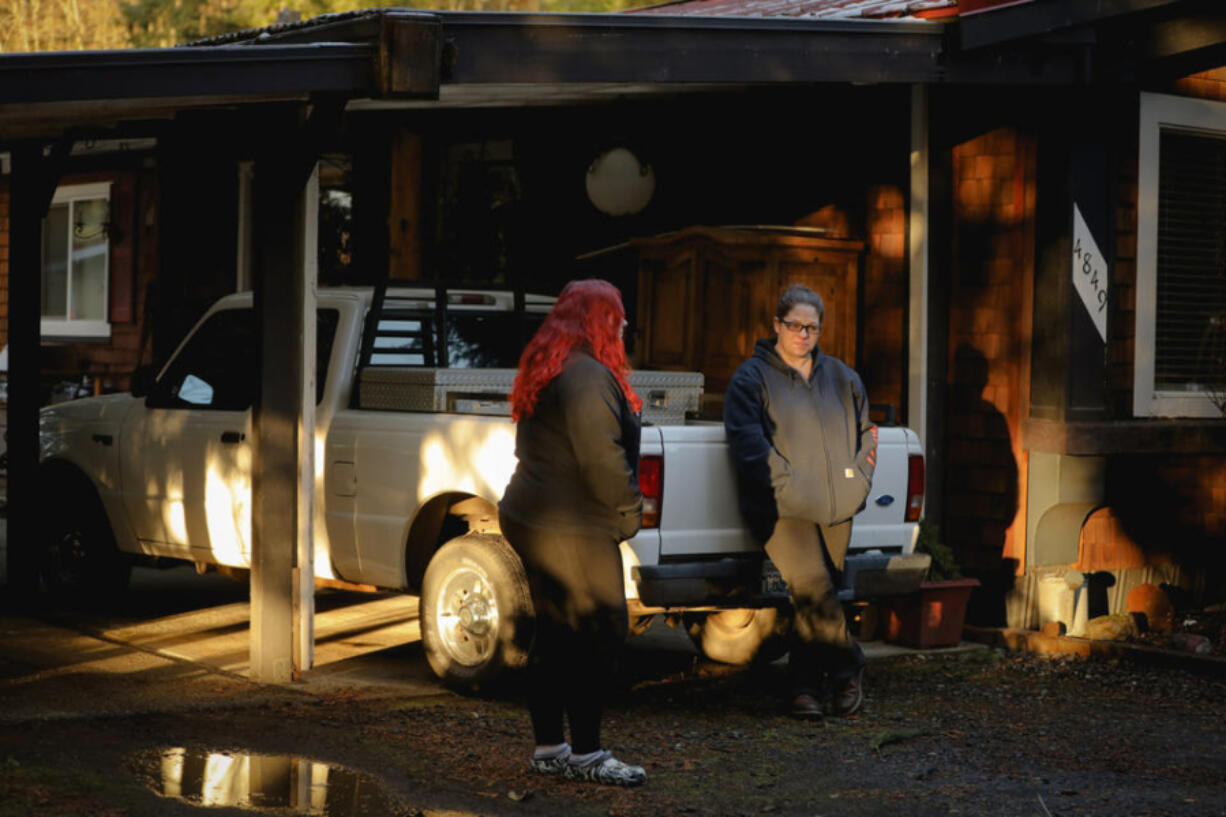 Destiny Armstrong and her daughter Katelin Rayment stand in the driveway of their home in Elma, one of the few places where they can get reliable wifi service at their house.