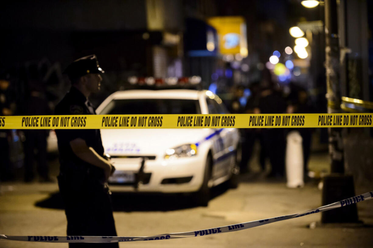 New York Police Department officers and detectives investigate a crime scene.