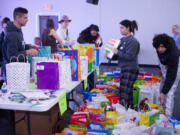 The birthday kit assembly event Saturday at River City Church in Vancouver was supposed to go from 9 a.m. to 12:30 p.m., but because of the 60 volunteers who showed up -- more than double the expected number -- the work was done before 10 a.m.