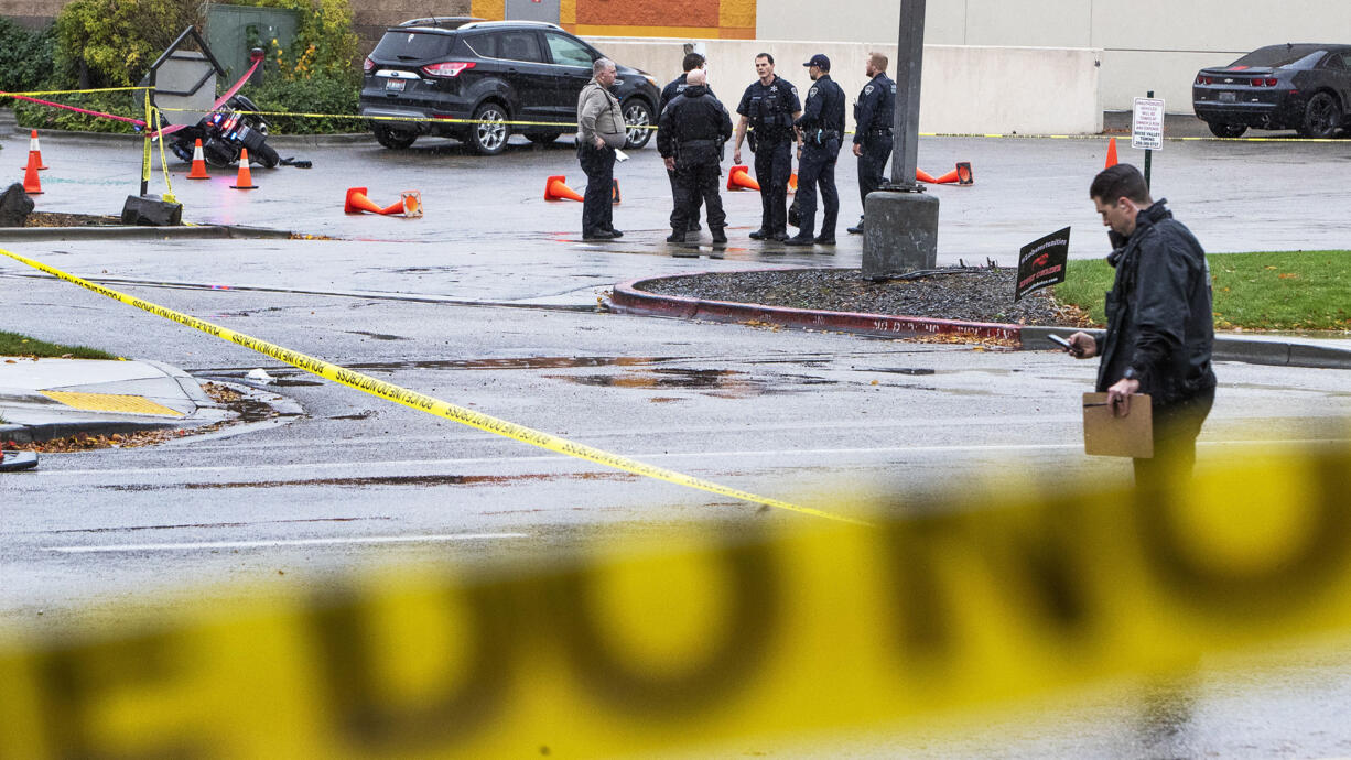 In this file photo, police collect evidence in a parking lot near Dave and Busters near Boise Towne Square where there was a shooting incident on Oct. 25, 2021 in Boise, Idaho.