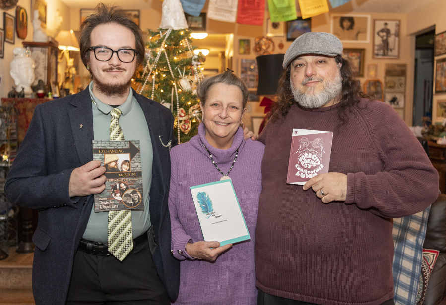 Angelo Luna, from left, Toni Lumbrazo Luna and Christopher Luna display their respective books at home in Hazel Dell. The family members have all authored books of poetry.