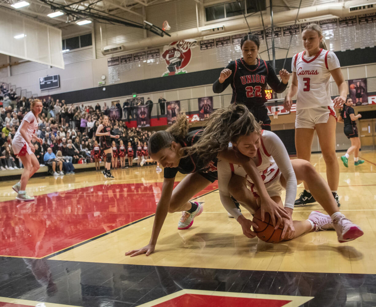 Camas sophomore Keirra Thompson, right, and Union sophomore Layla Senderson fight for a loose ball during Tuesday's 4A Greater St. Helens League game at Camas. The Papermakers went on to win 63-52.