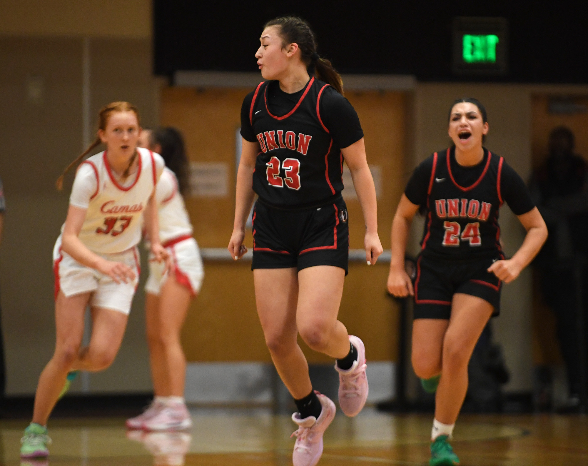 Union's Brooklynn Haywood, center, reacts after making a shot Tuesday, Jan. 3, 2023, during the Papermakers’ 63-52 win against Union at Camas High School.