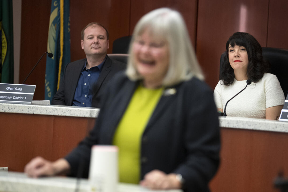 Clark County's newest councilors Glen Yung, left, and Michelle Belkot, right in white, listen to Councilor Sue Marshall address the audience during Tuesday's swearing in ceremony.