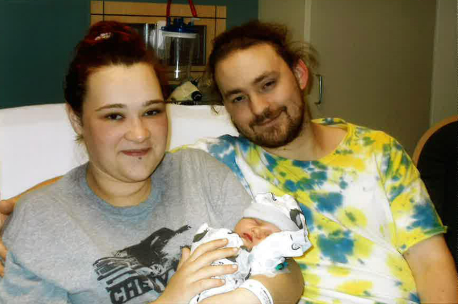 First-time parents Kimberly and Charles Mastberg-Hanen hold their newborn son, Grayson Daryl-Lynn Mastberg-Hanen, the first baby born in 2023 at PeaceHealth Southwest Medical Center.