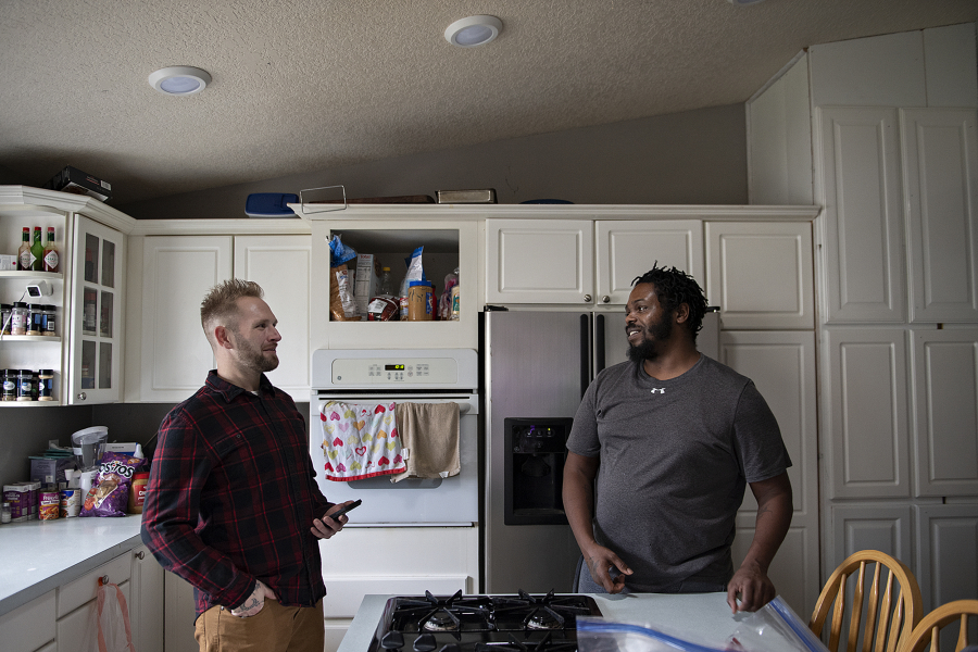 Jonathan Cline, left, who is recovering from opioid abuse and currently on medication-assisted treatment, chats with housemate Kedric Gibbs, who is also in recovery and taking part in the treatment program, at Xchange Recovery's Vancouver house Friday morning.