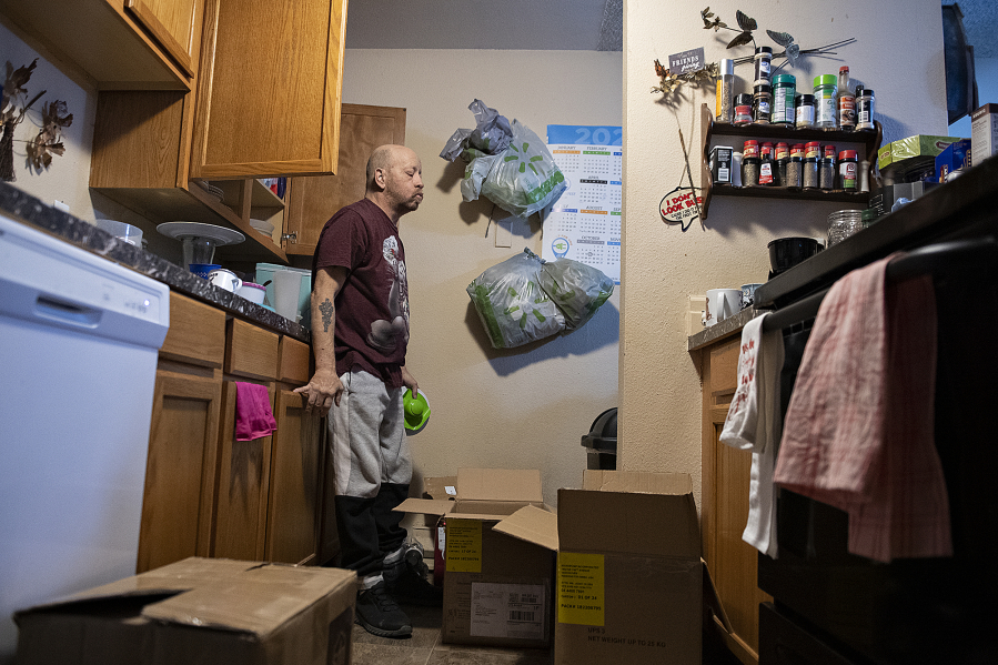 Steven Doble packs up items in his kitchen, preparing to move out of his Vancouver apartment where he's lived for eight years. Doble and his roommate are facing eviction, unable to pay their rent due in part to a long wait time for federal disability benefits.