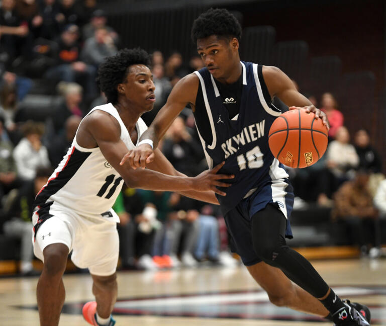 Skyview junior Demaree Collins, right, dribbles down the court defended by Union senior Samair Thompson on Friday, Jan. 6, 2023, during the Storm’s 61-41 loss to Union at Union High School.