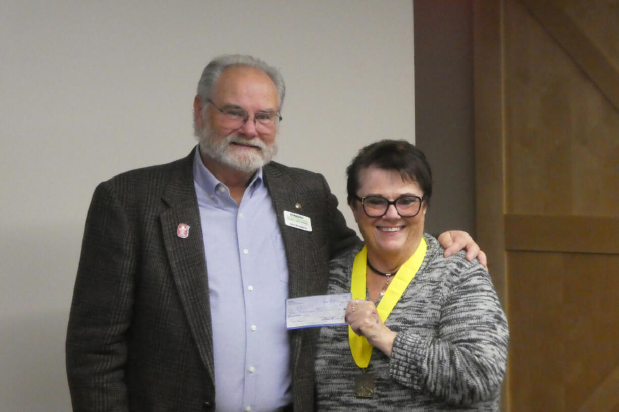 In a special celebration, Pam Moore presented a $9,000 check to John Brookens, past president of the Kiwanis Doernbecher Children's Cancer Program.