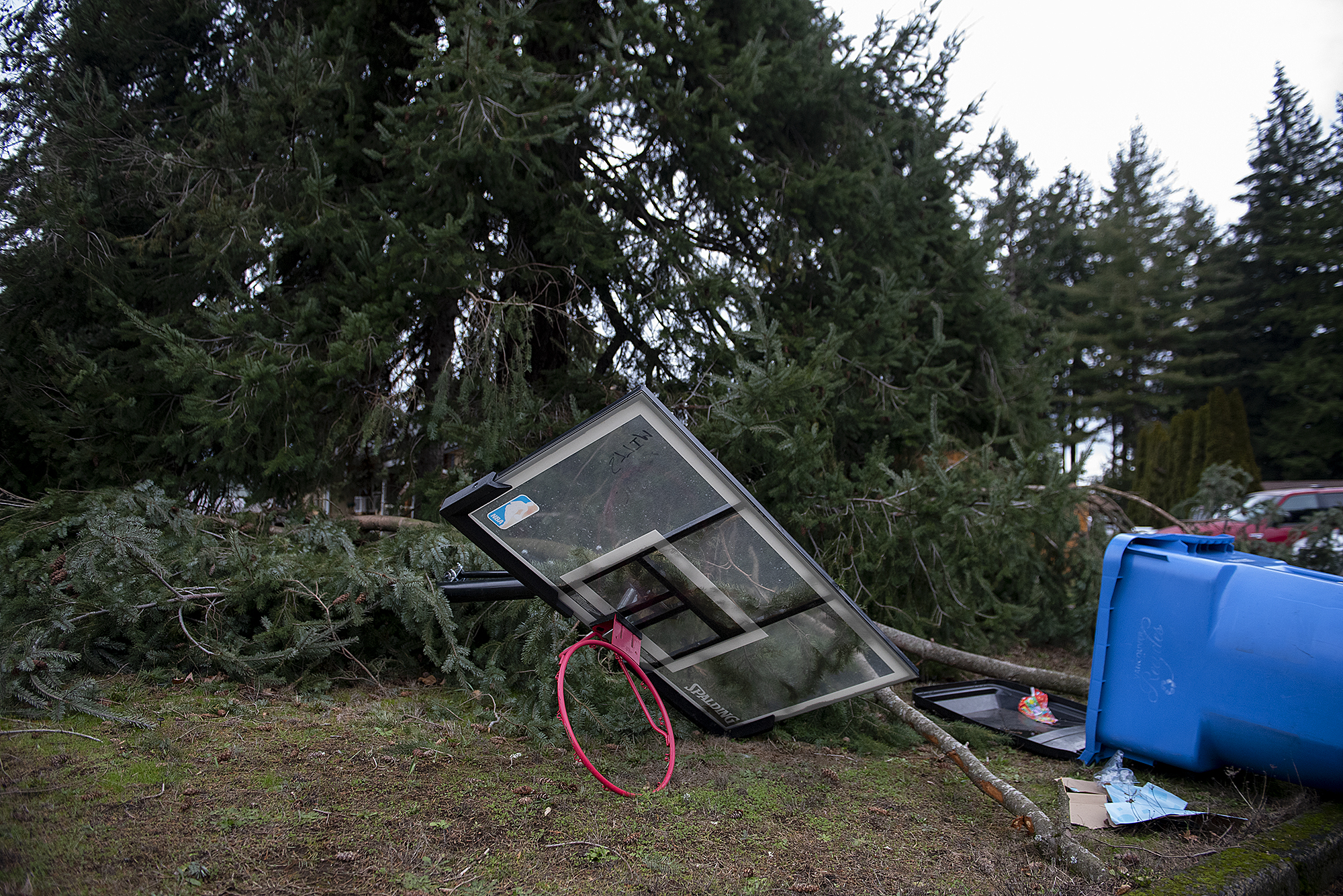 A toppled basketball hoop and recycling bin are seen along Northeast 143rd Avenue on Thursday morning, Jan. 5, 2023.