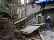 Bill Drummond of Vancouver looks over the damage Thursday morning, Jan. 5, 2023, after high winds caused a Douglas Fir to crash through two of his upstairs bedrooms in Hazel Dell on Wednesday evening. Drummond, who has lived at the home for 31 years, said no injuries were reported and he is taking the incident in stride. "It'll get fixed…Luckily we are okay," he said.