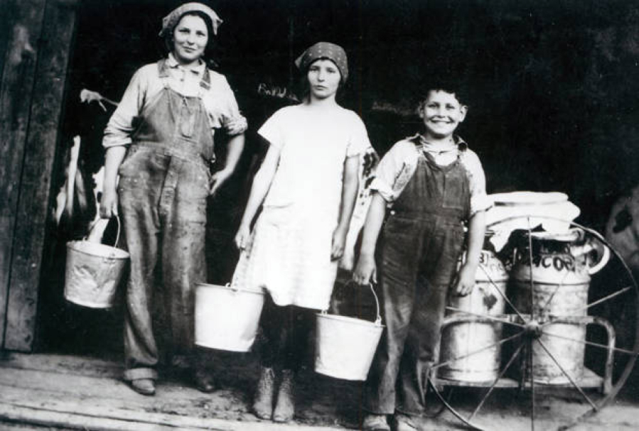 Margaret Eldred, left, stands next to an unidentified girl and boy at the entrance of a milking barn. There’s a cow in the left side background and milk containers on the right. During the Depression, dairy farming was the most prominent business in Clark County, boosting the local economy by $4 million to $5 million a year. When distributors reduced payments for raw milk to increase profits, the farmers rebelled by blacklisting them, starting a milk war that turned violent in 1931.