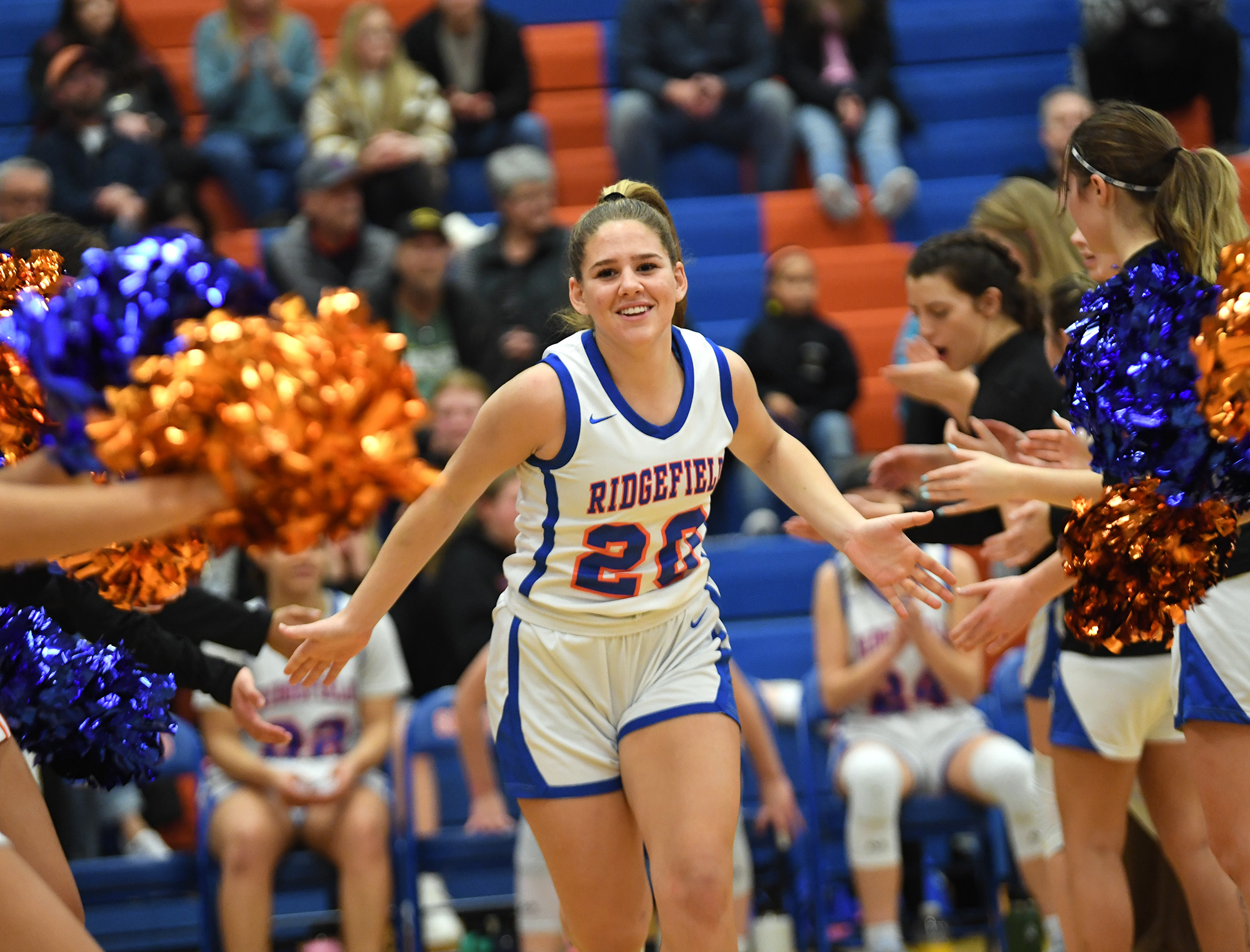Ridgefield sophomore Nora Martin high fives teammates and cheerleaders Tuesday, Jan. 10, 2023, before the Spudders’ 41-39 loss to Columbia River at Ridgefield High School.