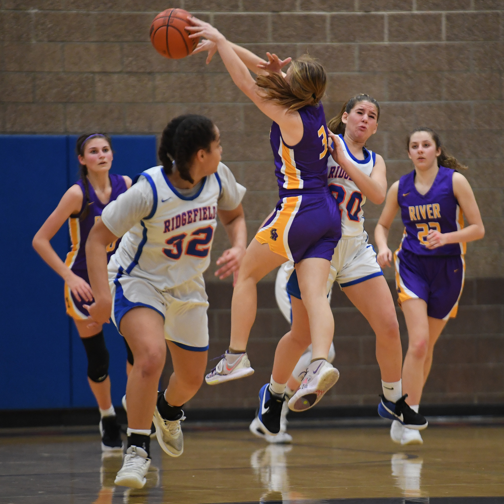 Columbia River sophomore Marley Myers,  shown here in January center, blocks a pass from Ridgefield sophomore Nora Martin.