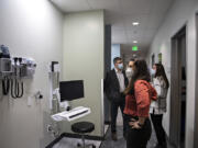 Dr. Michael Paull, from left, medical director at Vancouver Clinic Mental Health Center, joins geriatric psychiatrist Dr. Tenley Rivera and clinic manager Stacey Regalado during a tour of the new facility. The facility has one traditional exam room for use in administering medication to some patients.
