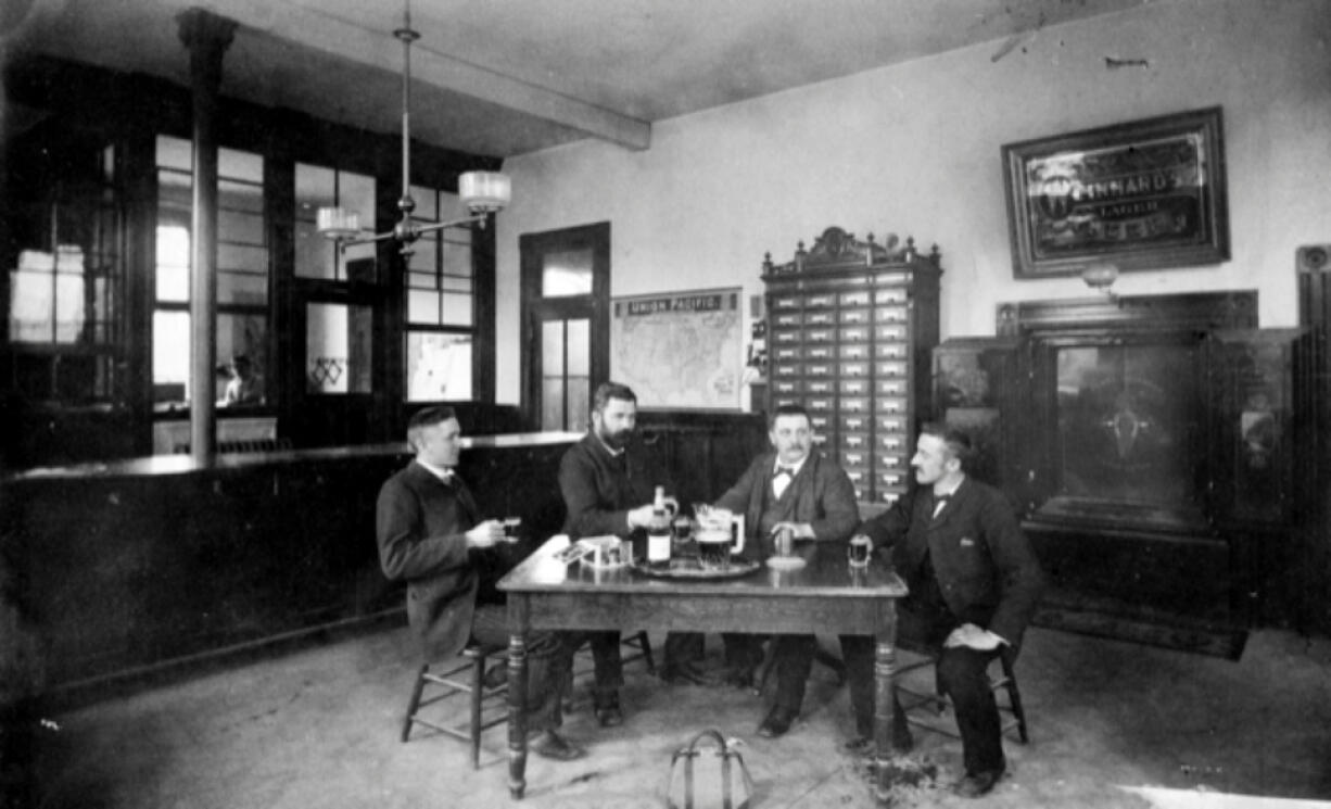 This lunchroom shows Weinhard Brewery employees sitting around a table in about 1910. They worked nine-hour days, six days a week. Henry Weinhard (1830-1904) followed the 1891 United Brewery Workmen Contract entitling workers to free beer during their shifts, a common practice in breweries then.