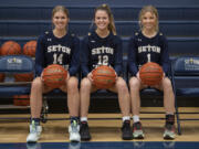 Seton Catholic High School basketball players Hannah Jo Hammerstrom (14), Anna Mooney (12) and Keira Williams (1) are pictured in their school's gym Thursday afternoon, Jan. 12, 2023.