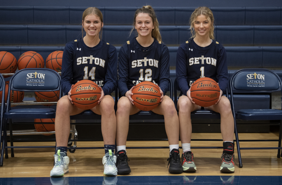 Seton Catholic High School basketball players Hannah Jo Hammerstrom (14), Anna Mooney (12) and Keira Williams (1) are pictured in their school's gym Thursday afternoon, Jan. 12, 2023.